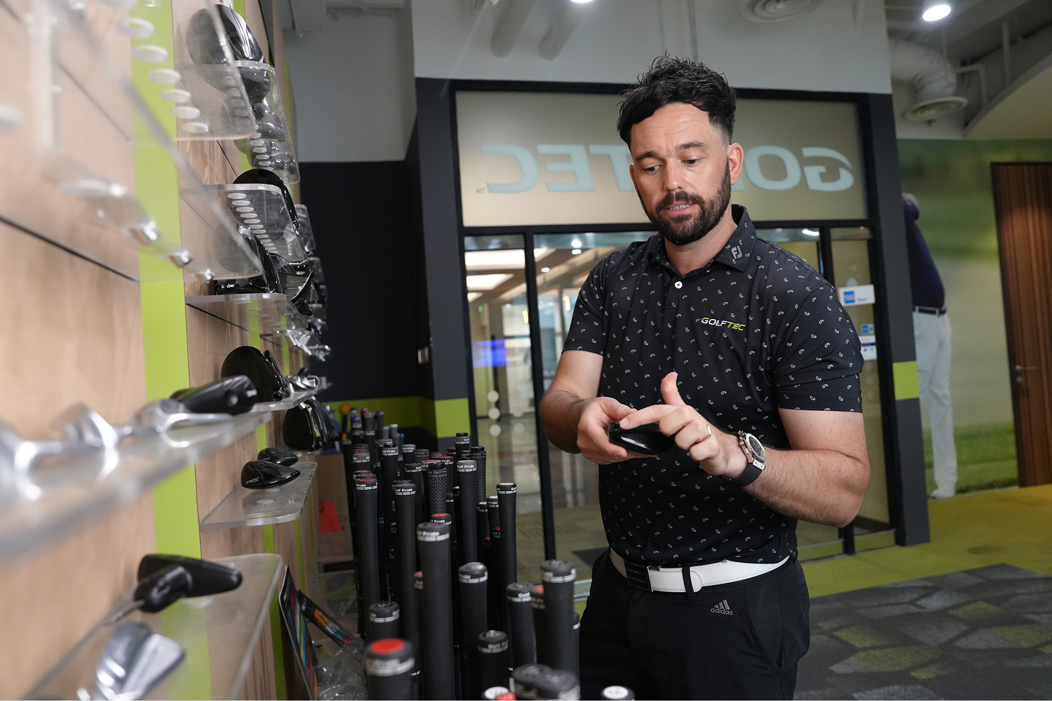 Jamie Whenman at GolfTec equipment display
